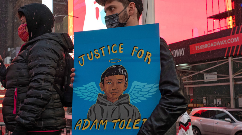 Protestor holding Adam Toledo sign