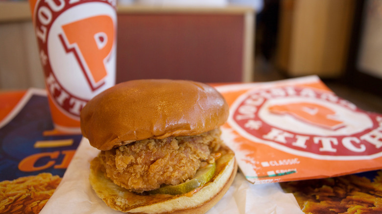 A drink and chicken sandwich from Popeyes