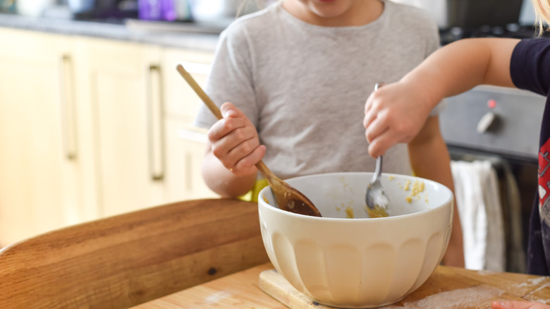 kids stirring batter for baking cookies