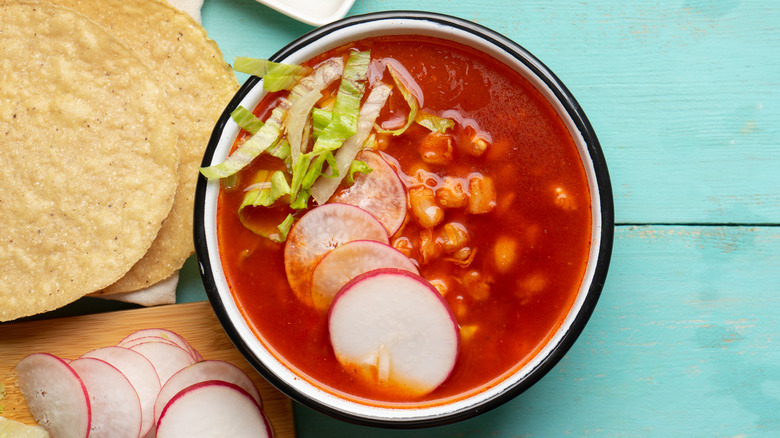 Red pozole on turquoise table