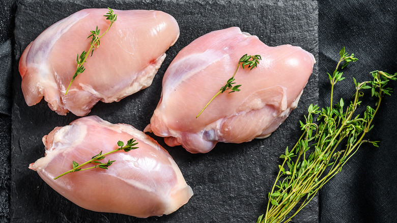 Pink, raw chicken thighs