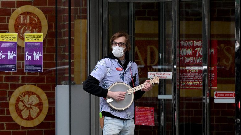 Trader Joe's employee playing banjo for customers