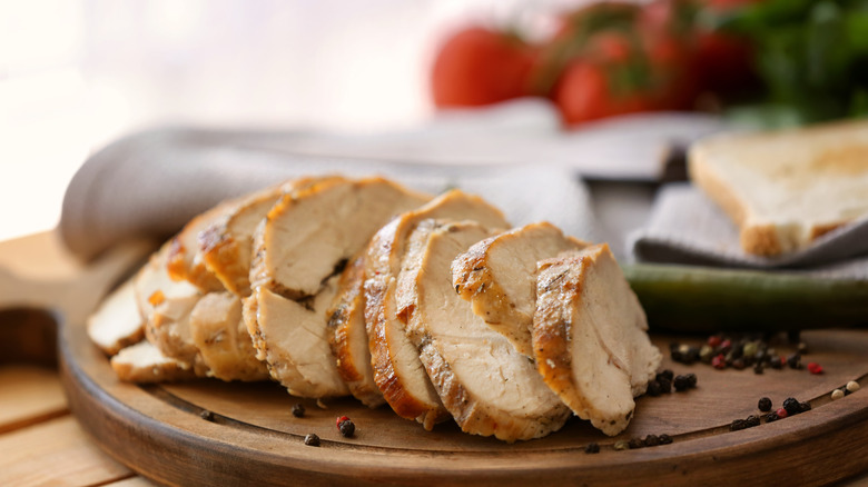 Sliced turkey breast on a wooden cutting board