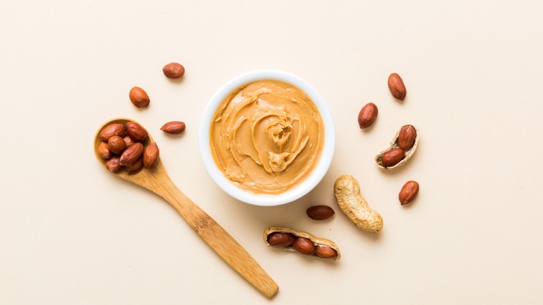 Man eating from a jar of peanut butter