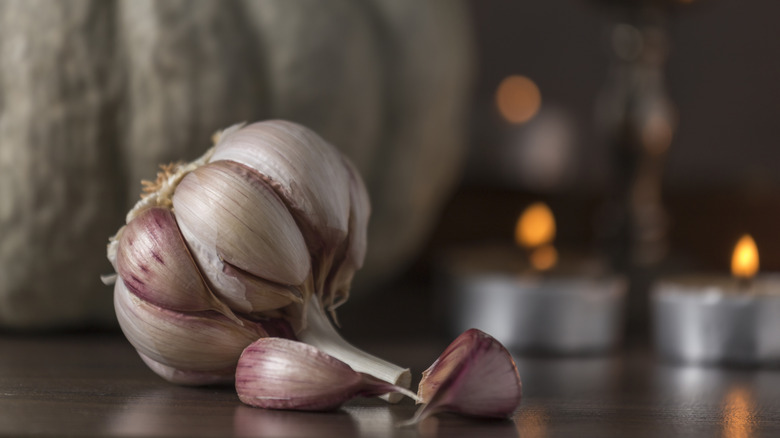 Garlic bulb in front of candles