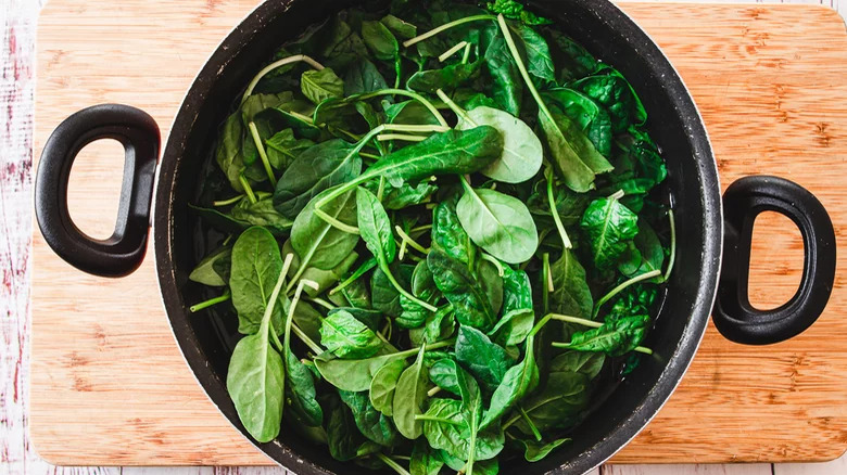 spinach in a pan of water