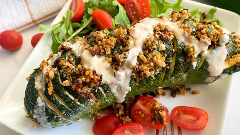 hasselback zucchini with tahini sauce and tomatoes