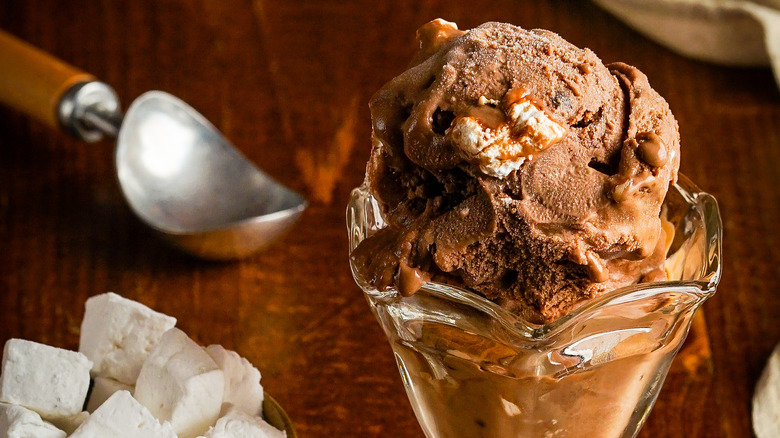Rocky Road sundae next to marshmallows and ice cream scoop