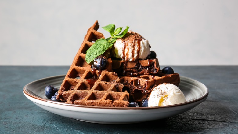 Chocolate waffles with ice cream and blueberries