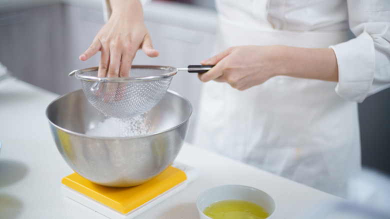 A chef making batter in a mixing bowl