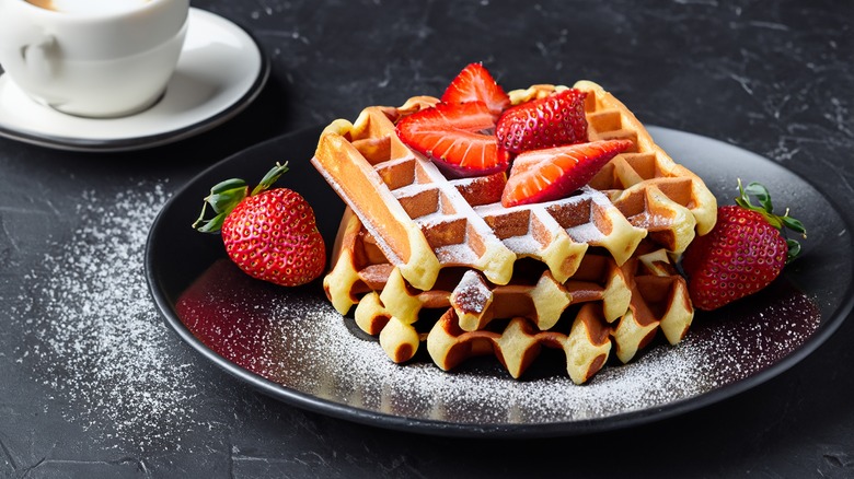 Crispy Belgian waffles on a plate with strawberries