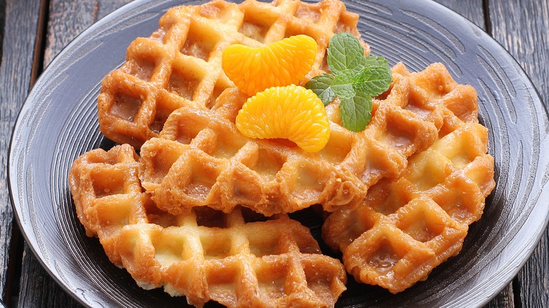 A plate of yeast-risen waffles with garnish