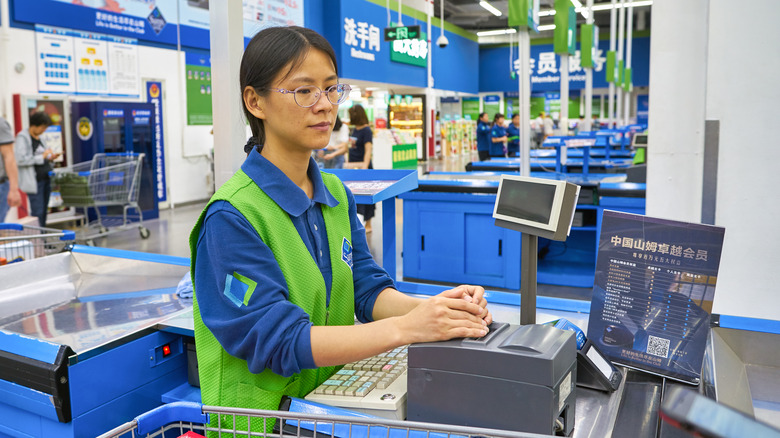 Walmart employee at register