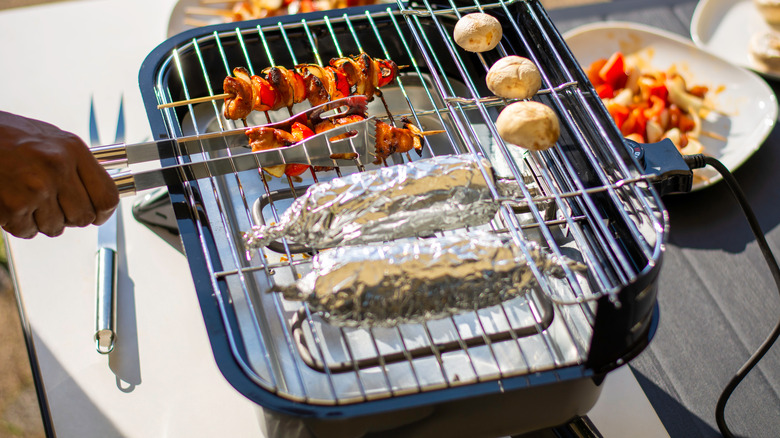 Grilling corn in aluminum foil 