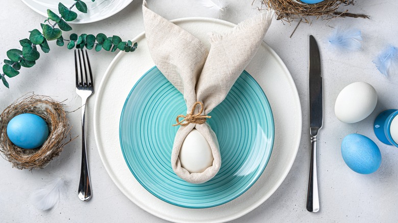 Egg wrapped in napkin folded into rabbit ears