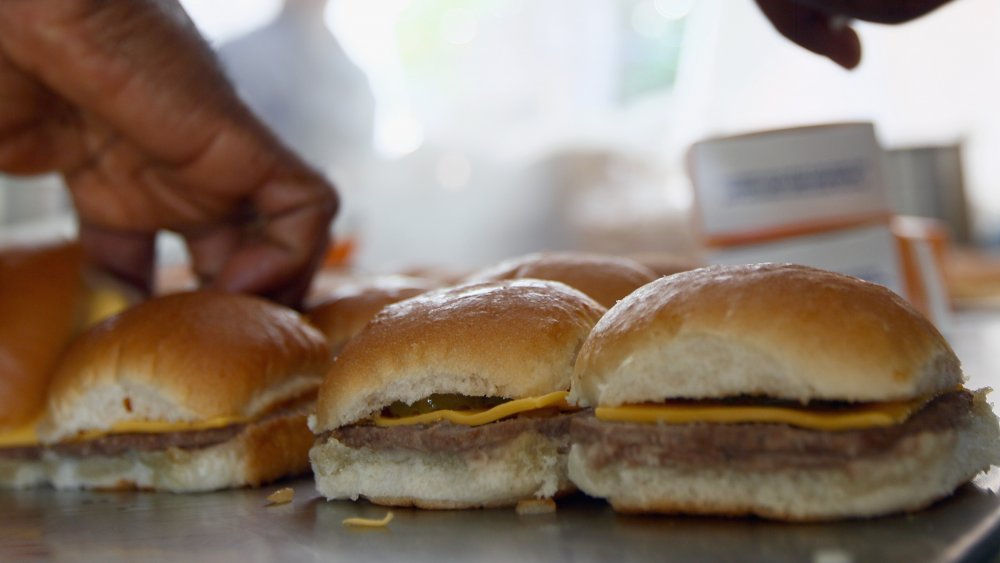 Several white castle sliders lined up in a row.