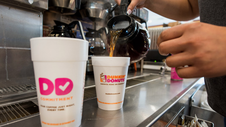 Pouring coffee at Dunkin' store