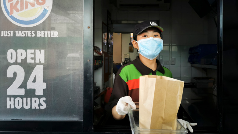 Burger King employee handing over order