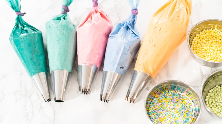 Pastry bags filled with colorful frosting