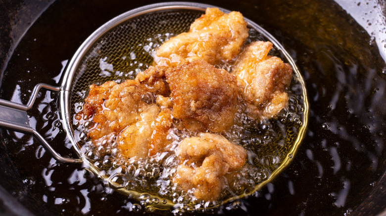 chicken frying in hot oil