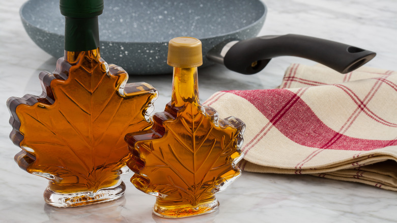 Maple syrup in leaf shaped bottles and a frying pan