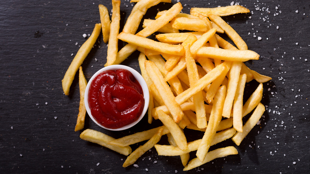 Ketchup and fries on a dark background