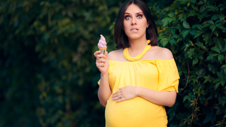 pregnant woman eating soft serve