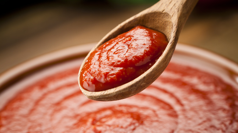 tomato paste being dipped