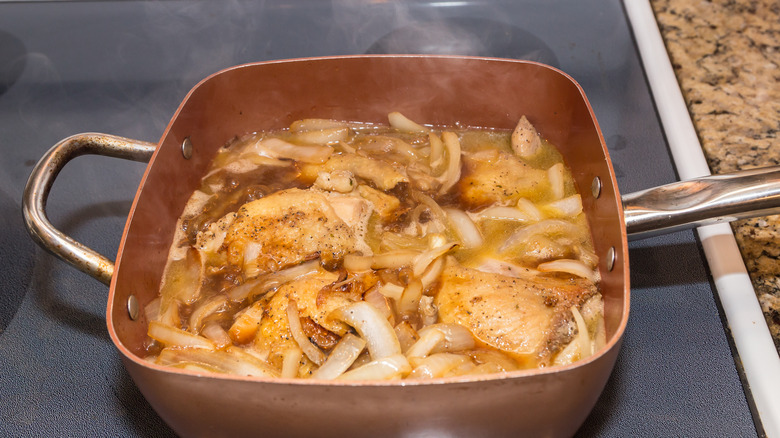 chicken and onions poaching in white wine