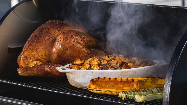 Thanksgiving dinner cooking on a grill