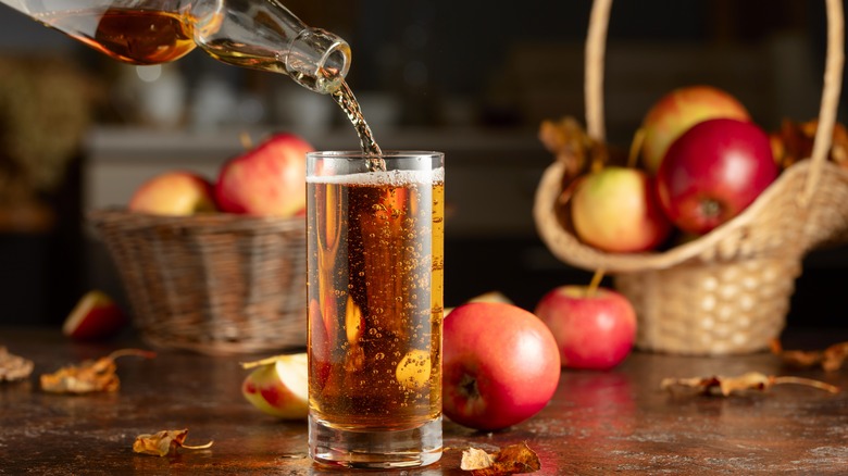 Pouring apple cider from bottle