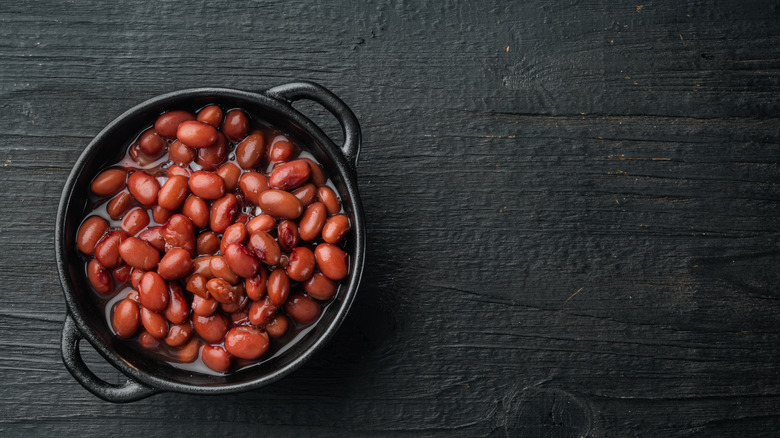 Bowl of red beans on black background