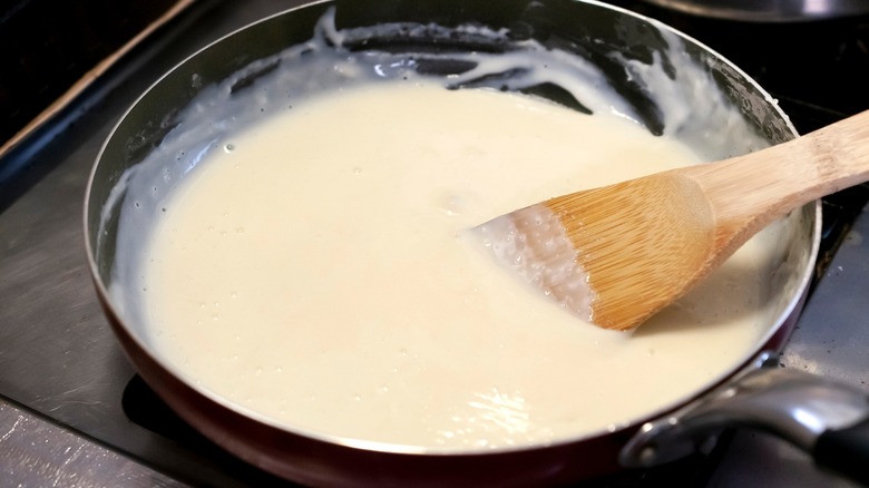 heating béchamel sauce on griddle