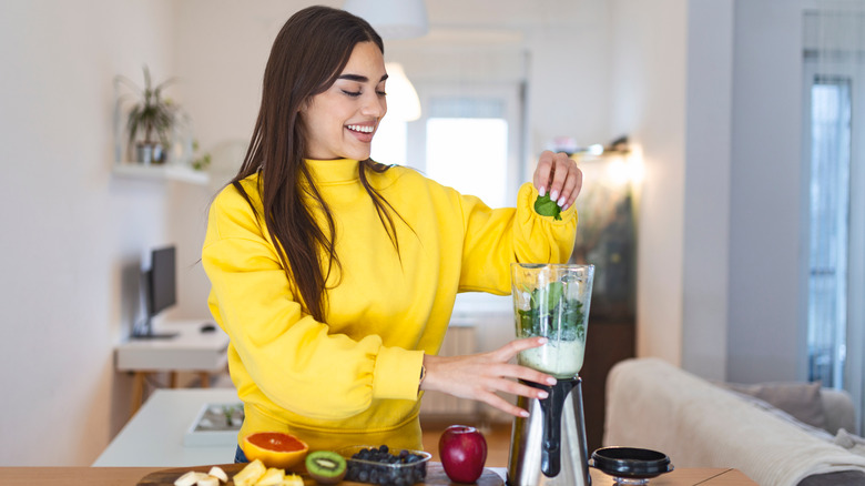 Woman blending a smoothie