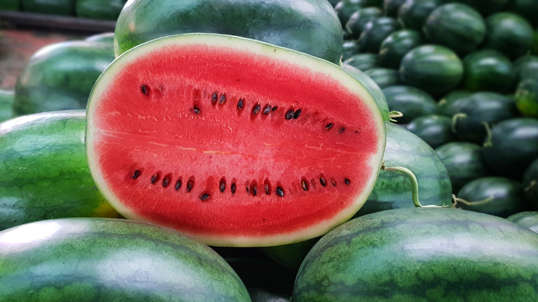 Cut watermelon stacked on whole watermelon