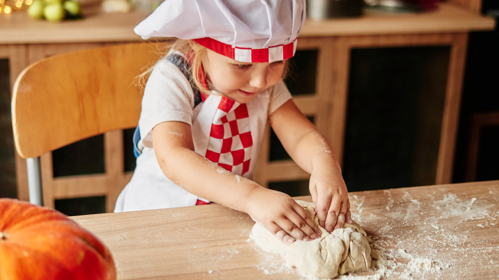 kid kneading bread dough