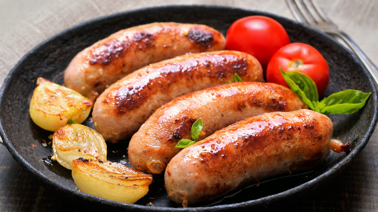 well-cooked sausage on black plate