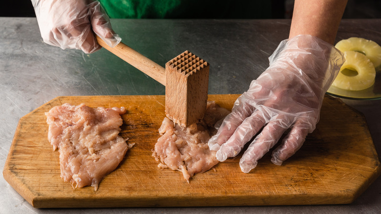 tenderizing chicken breast with mallet