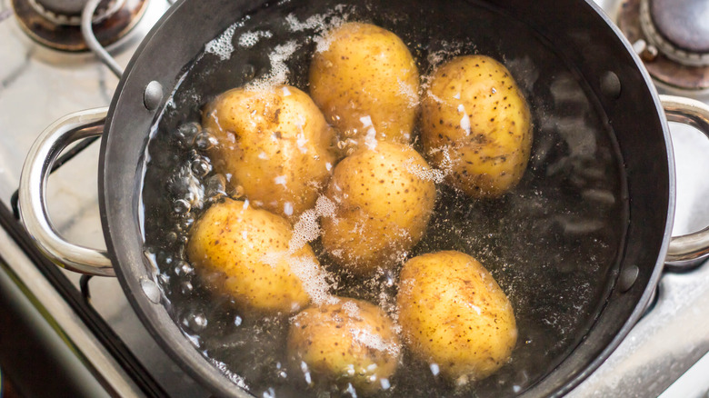 Potatoes boiling in saucepan