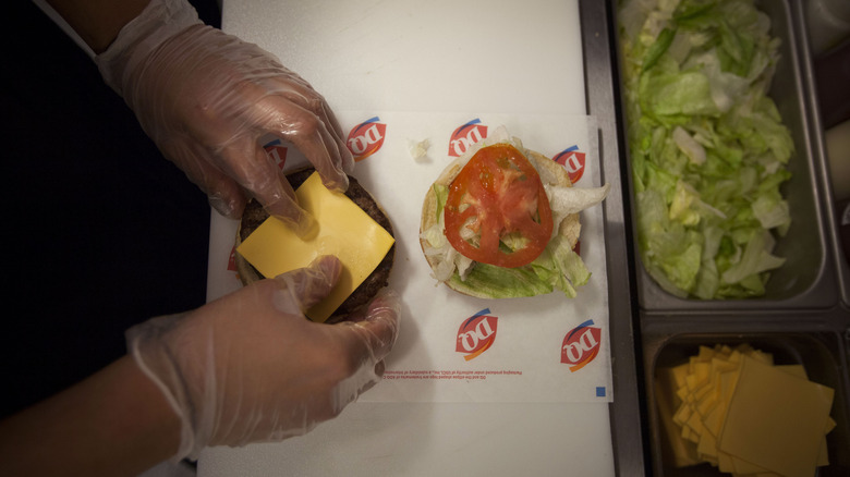 Worker prepping burger at Dairy Queen