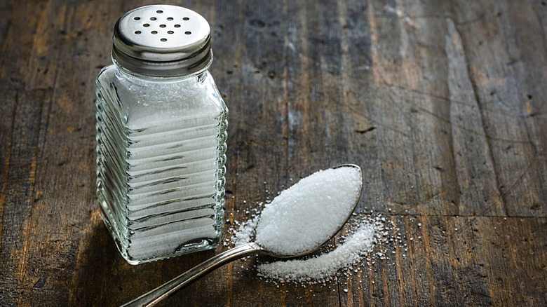 salt shaker and spoon of salt