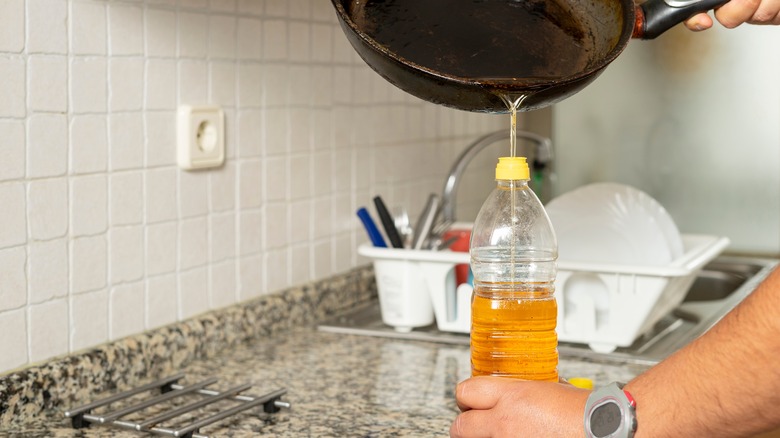 pouring oil into bottle