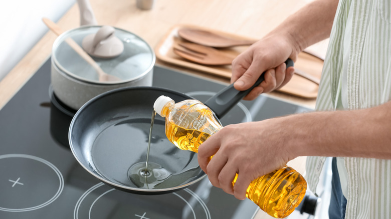 pouring oil into pan