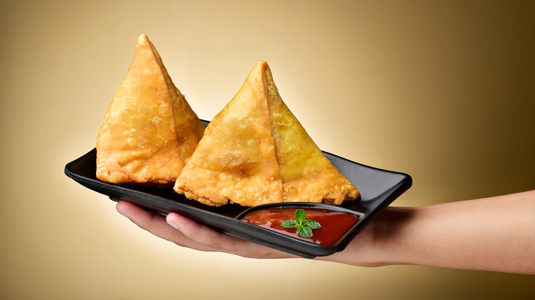 Two samosas on a tray