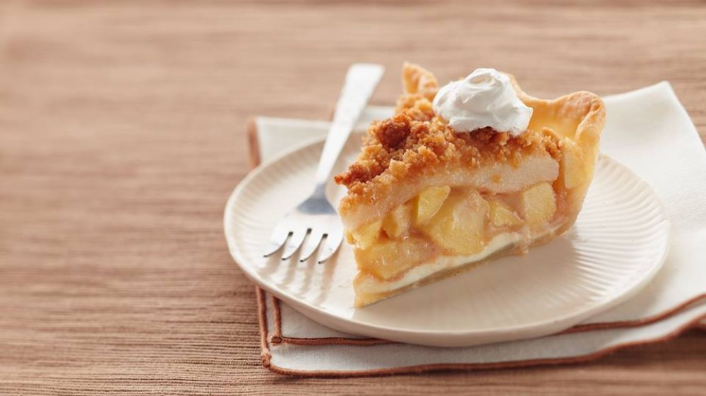 dollop of whipped topping on apple pie