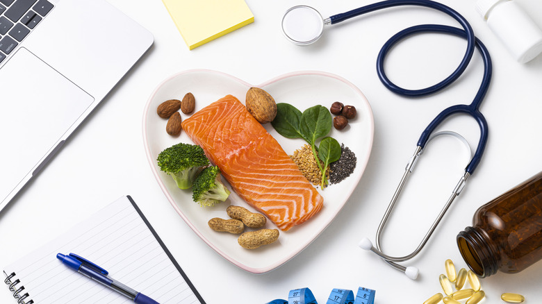 Heart-shaped dish filled with fish, nuts, and seeds