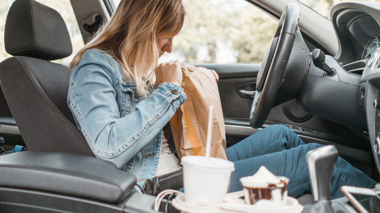 Woman with fast food order, including ice cream