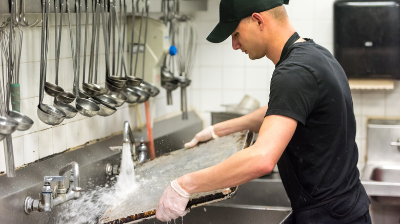 Fast food employee cleaning