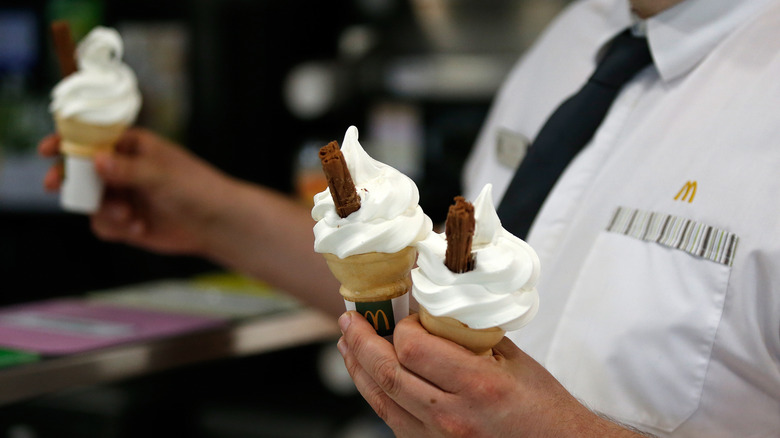 McDonald's employee holding ice cream cones