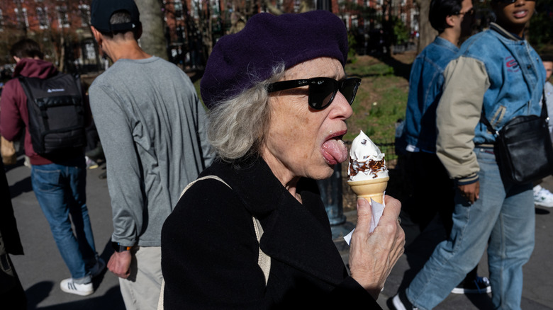 Woman eats soft serve ice cream cone in park